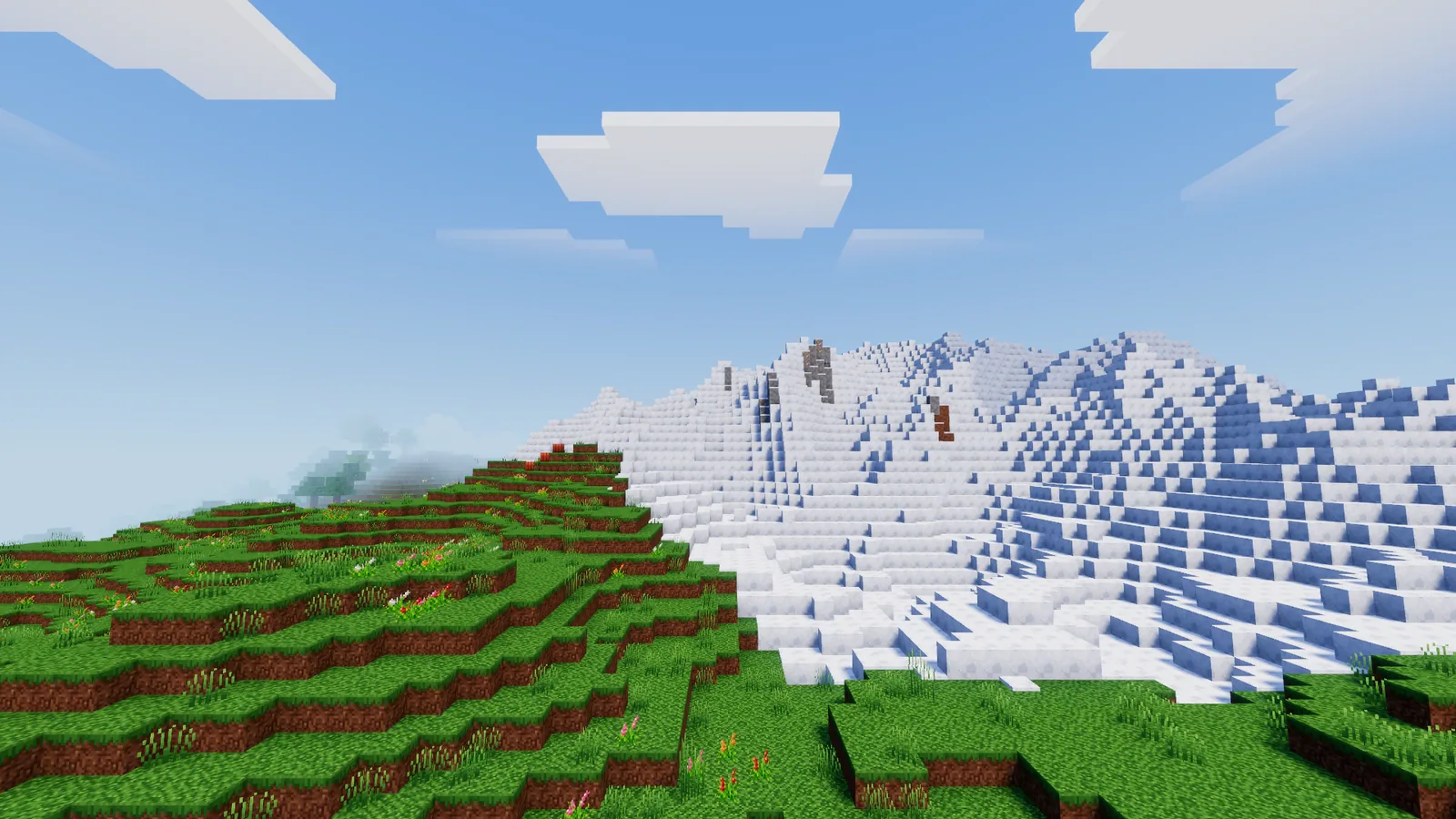 Snowy mountain peaks above the clouds' shadows